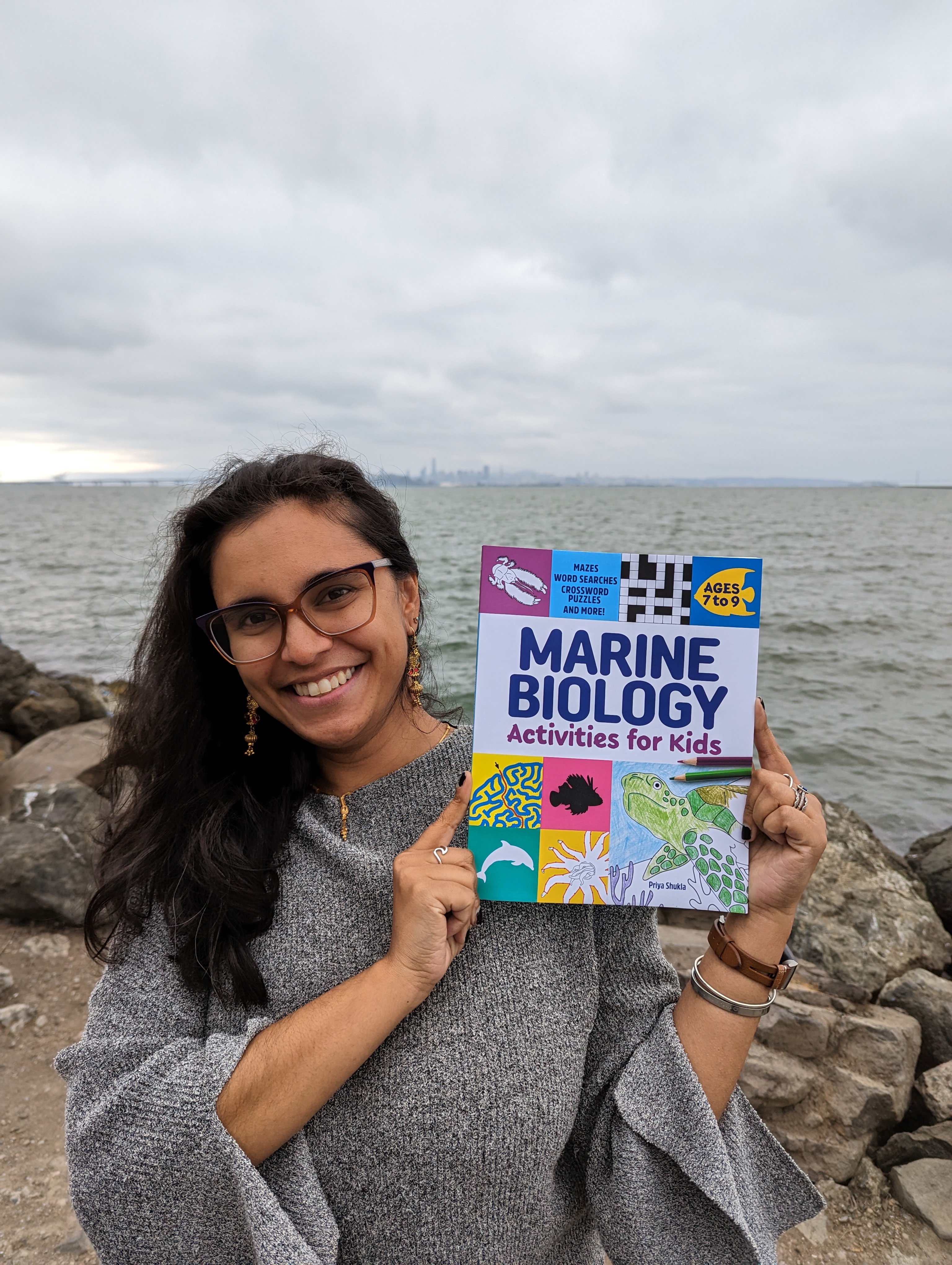 Priya holing her book, Marine Biology Activities for Kids